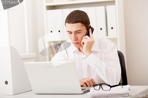 Image of businessman on phone sitting