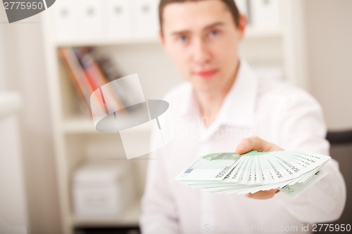 Image of man holding euro money