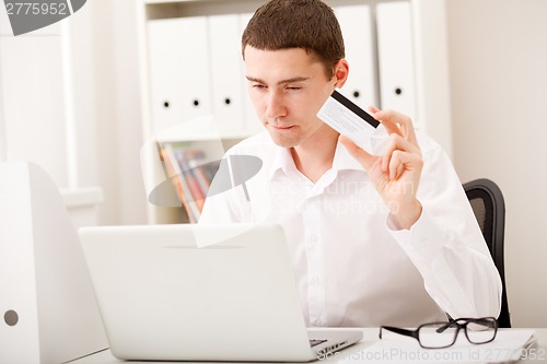 Image of man using credit card