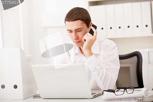 Image of man working and using laptop