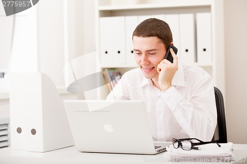 Image of businessman on phone sitting