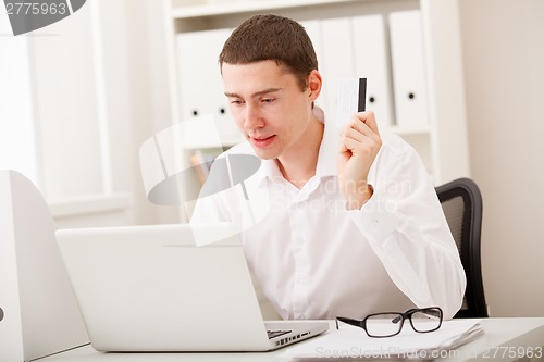 Image of man using credit card