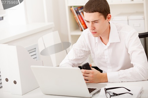 Image of man thinking in office