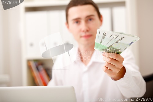 Image of man with Euro in office