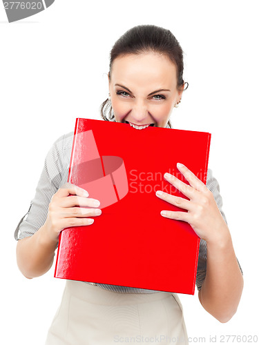 Image of business woman bites in a red binder