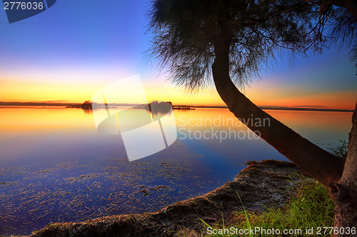 Image of Sunbeams reflected in the water at sunset 