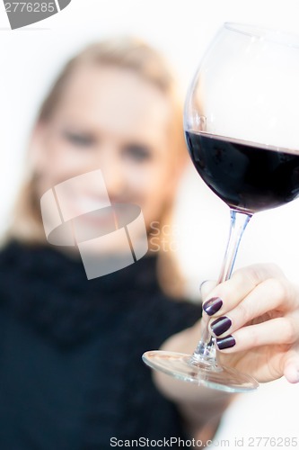 Image of Toasting with a glass of red wine.