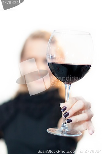 Image of Toasting with a glass of red wine.