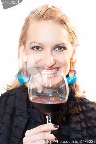 Image of Toasting with a glass of red wine.