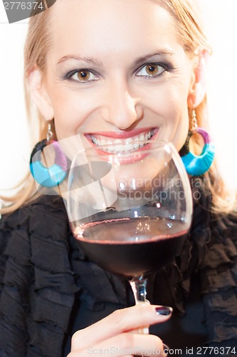 Image of Toasting with a glass of red wine.