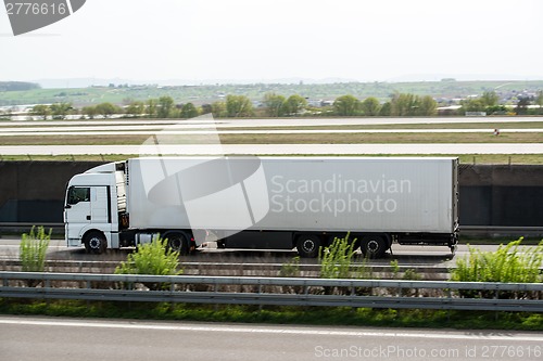 Image of White truck moving on a highway