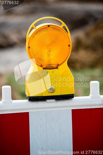 Image of yellow signal lamp on construction site