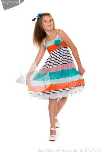 Image of dancing girl in a dress in the studio