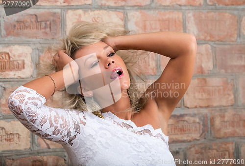 Image of Portrait of a girl with tousled hair and shows tongue