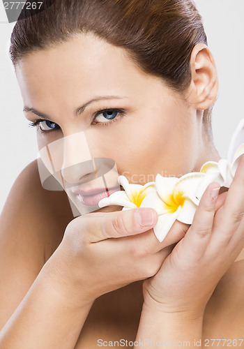 Image of Beautiful woman holding flowers