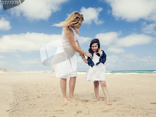 Image of Woman and her daughter on the beach