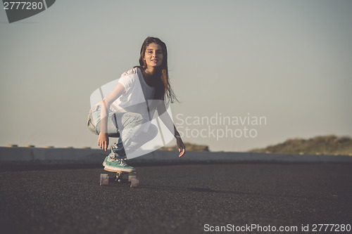 Image of Skater girl making dowhill