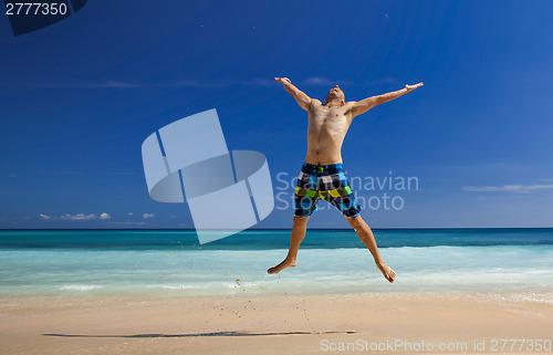Image of Man jumping on the beach