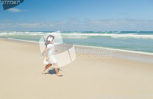 Image of Girl walking on the beach