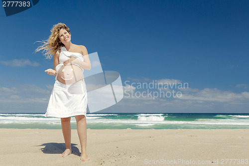 Image of Pregnant woman with a smile on the belly