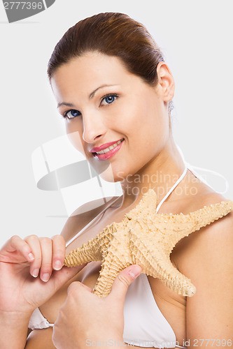 Image of Beautiful woman holding a starfish