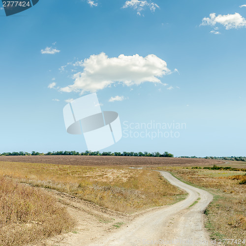 Image of two rural roads in steppe and cloud in blue sky