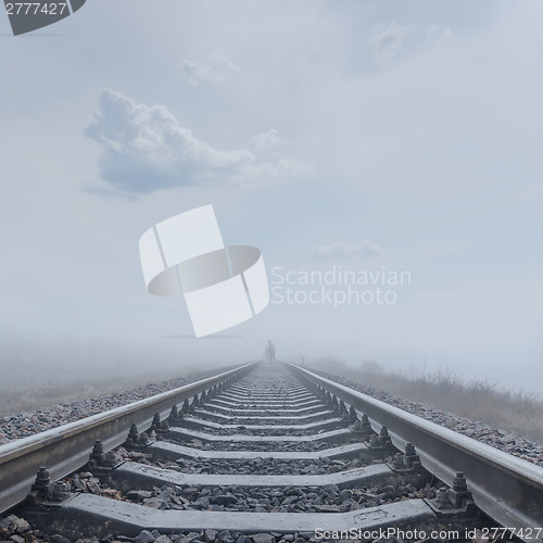 Image of railroad to horizon in fog