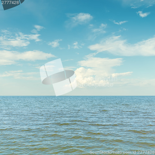 Image of blue sky with clouds over sea
