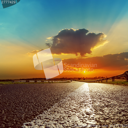 Image of fantastic sunset over asphalt road