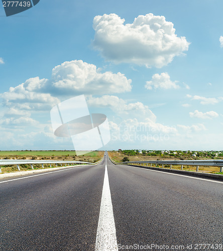 Image of asphalt road and clouds over it
