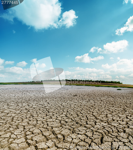 Image of cracked desert and clouds in sky