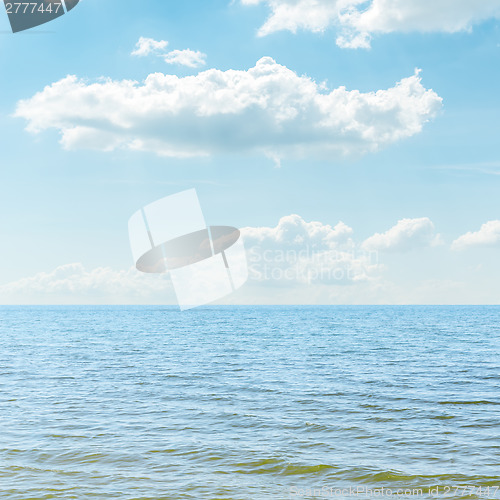 Image of blue sea and cloudy sky over it