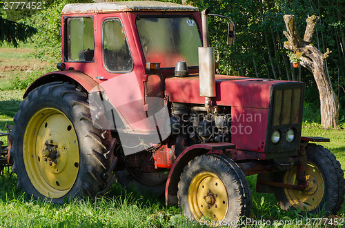 Image of rural red old farm tractor outdoor 