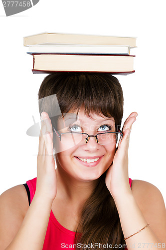 Image of young beautiful girl in glasses with books on head. isolated on 