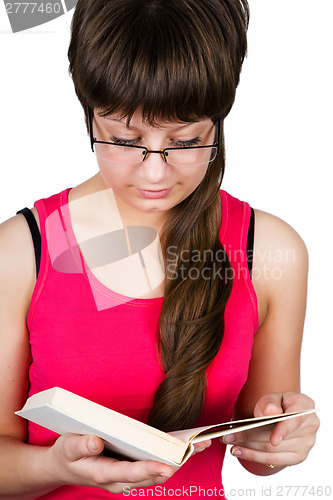 Image of young beautiful girl with glasses reading a book. isolated