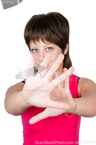 Image of young beautiful girl hiding behind her hands. isolated