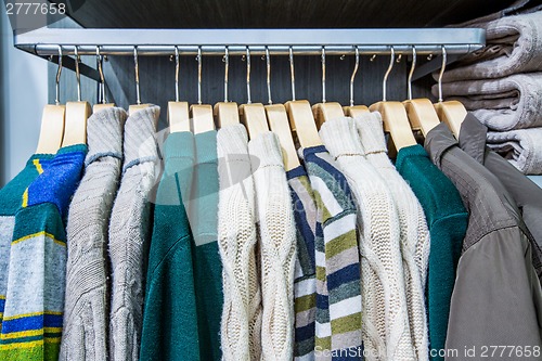 Image of Clothing on hangers in shop