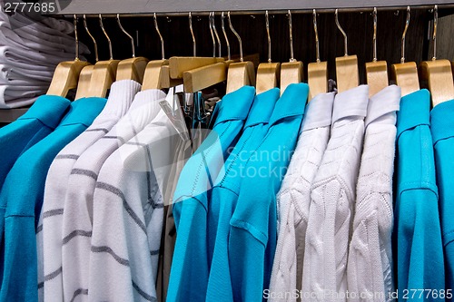 Image of Clothing on hangers in shop