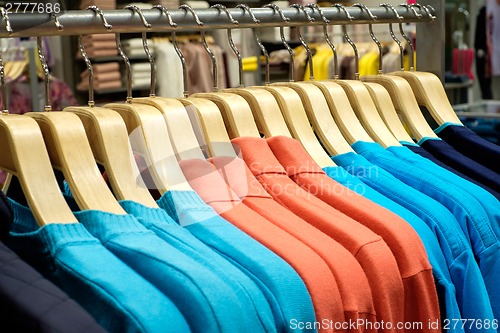 Image of Clothing on hangers in shop