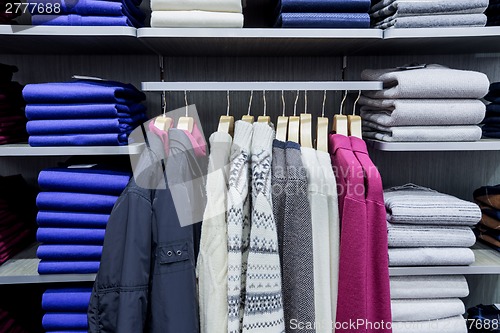 Image of Clothing on hangers in shop