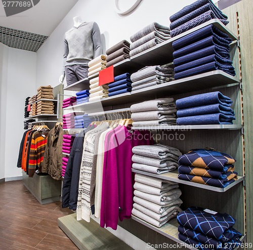 Image of Clothing on hangers in shop