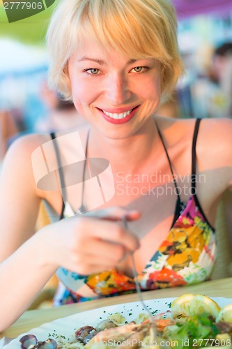 Image of Woman eating healthy food.