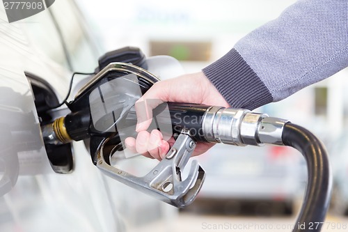 Image of Petrol being pumped into a motor vehicle car.