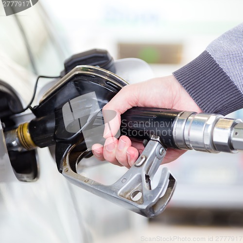 Image of Petrol being pumped into a motor vehicle car.