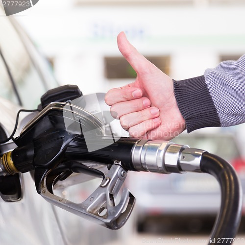 Image of Petrol being pumped into a motor vehicle car.