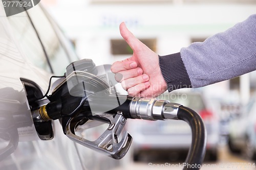 Image of Petrol being pumped into a motor vehicle car.