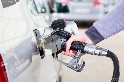 Image of Petrol being pumped into a motor vehicle car.