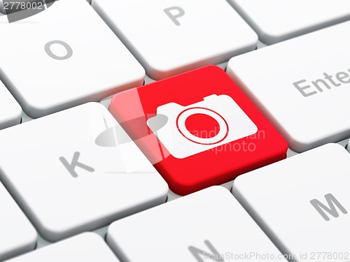 Image of Vacation concept: Photo Camera on computer keyboard background