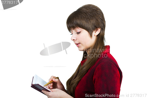 Image of Beautiful young girl with notebook and pen on a white
