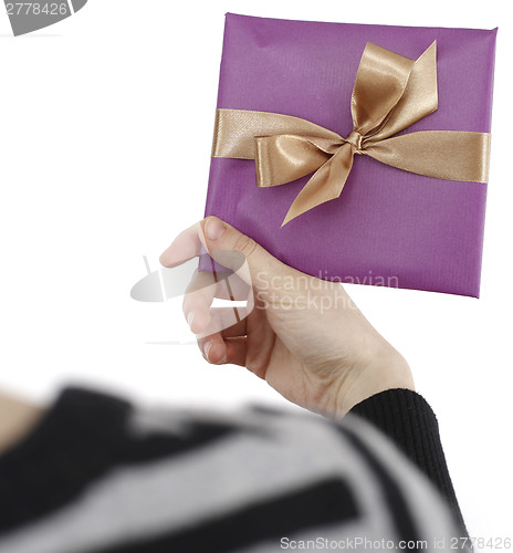 Image of Young woman holding a present